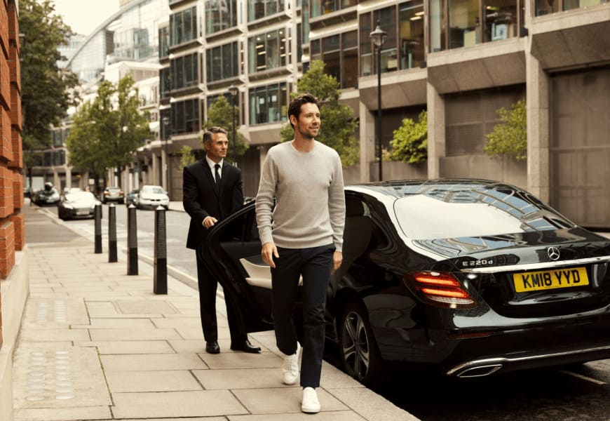 A car, bike, and people in a city setting